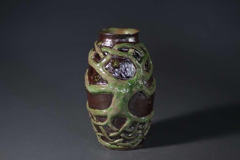 A ceramic vase with a celtic tree of life scuplted on the surface.